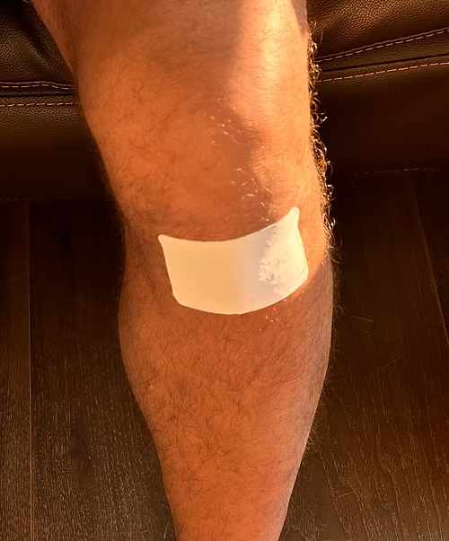 VIA PIEL wellness patch on a men's knee.